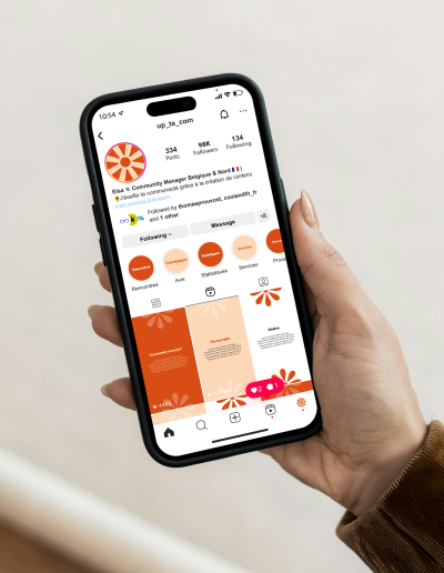 Un téléphone tenu en main affichant des stories Instagram pour le studio photographique Studio Luméa, ambiance solaire et amicale.